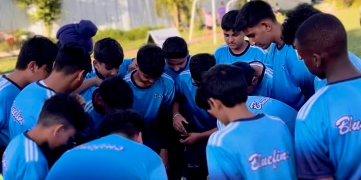 Bluefins Soccer Training Students Huddled on the Field